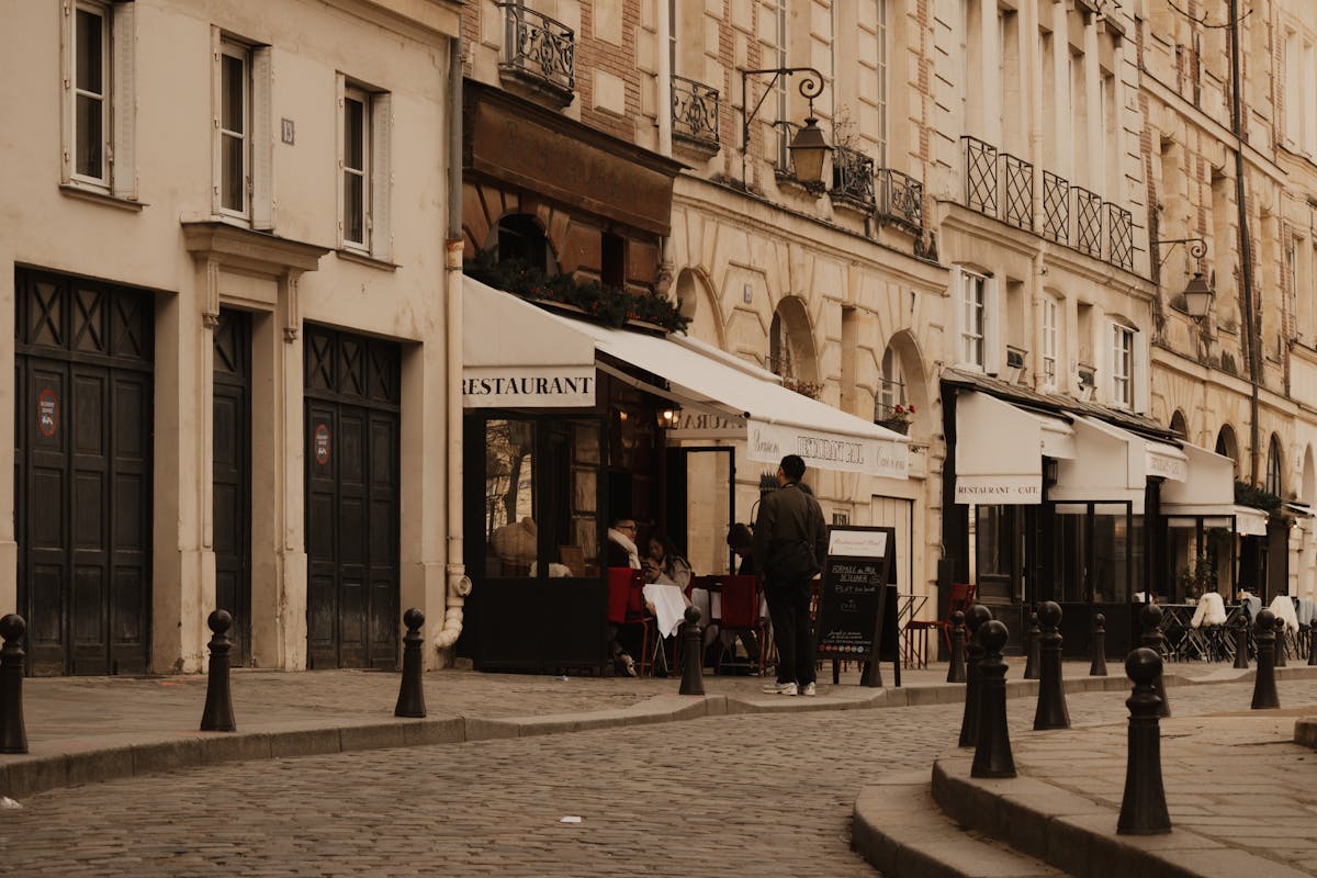 Cobblestone street in Paris with sidewalk cafes and classic architecture