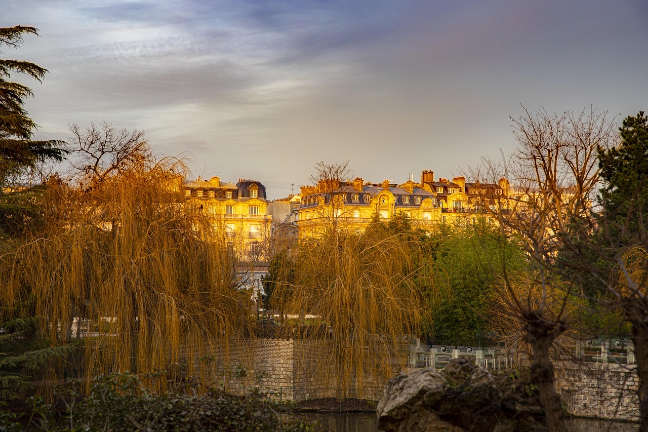 Paris Haussmann-era buildings with park and golden evening light