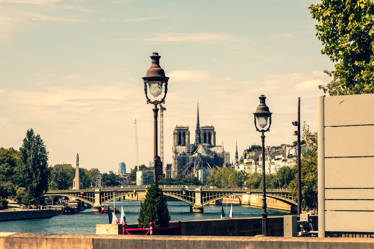 Notre-Dame Cathedral with vintage lampposts and the Seine River in Paris