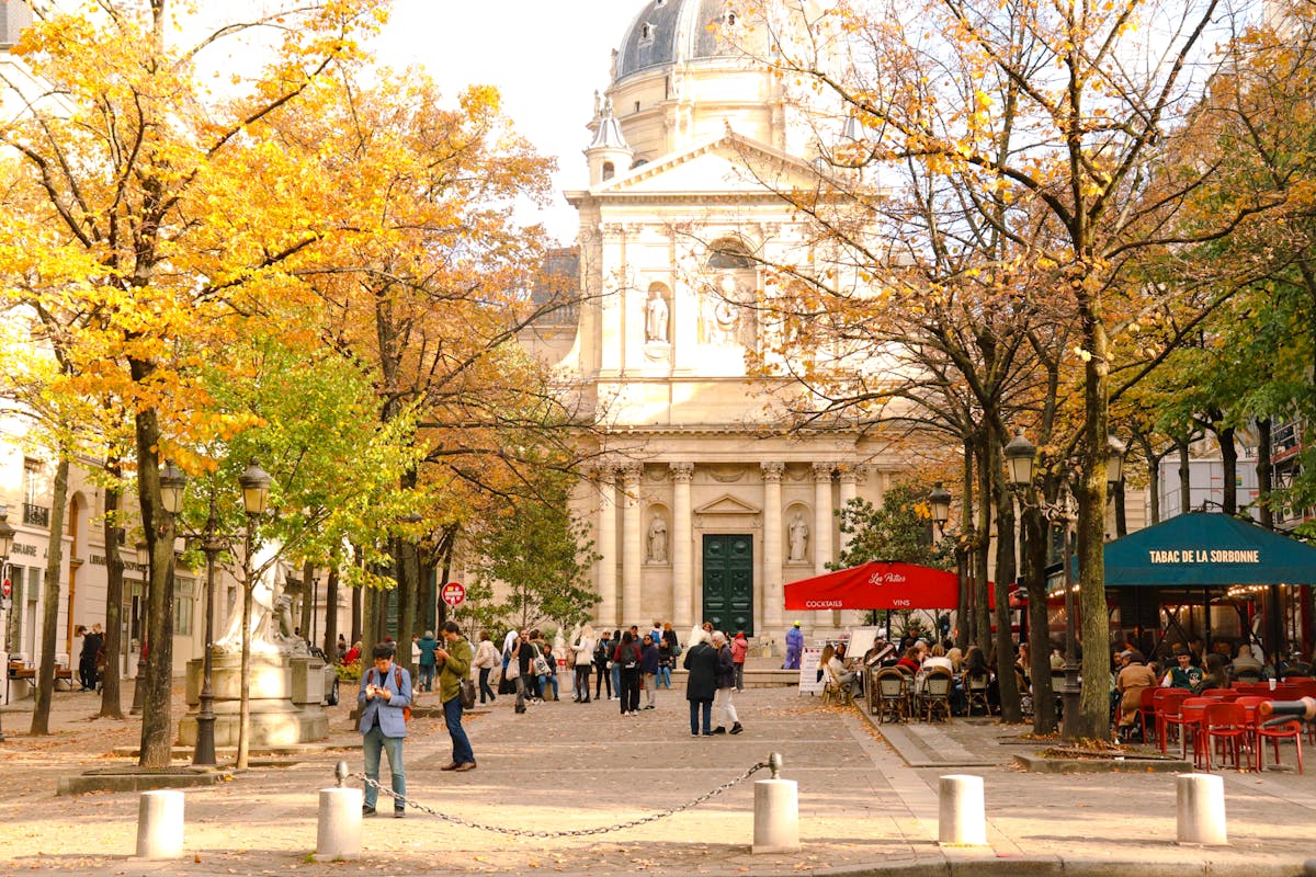 Autumn scene at the Sorbonne University in Paris with people and fall foliage