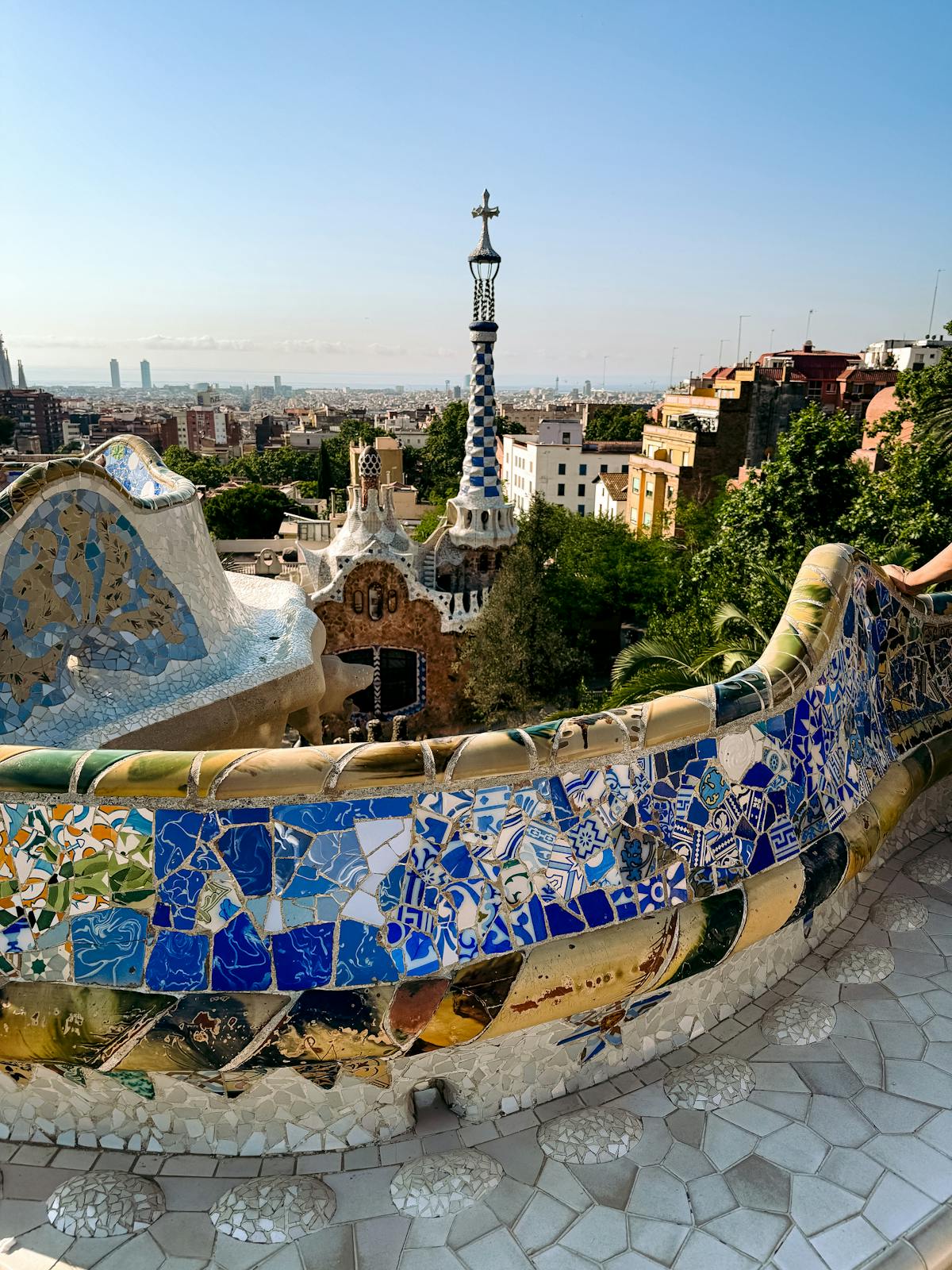 View from Park Guell showcasing vibrant mosaic tiles and Barcelona architecture