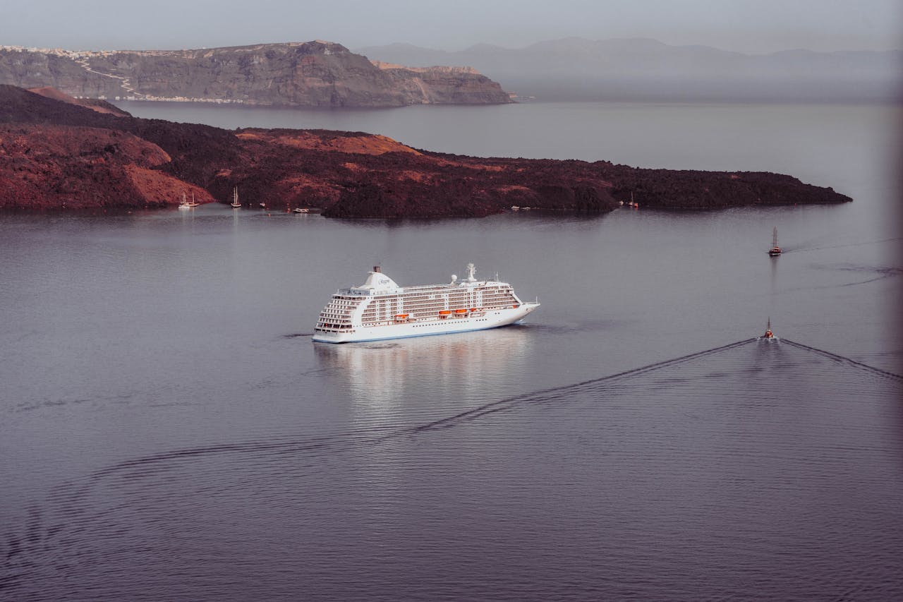 Aerial view of the Santorini volcanic coast and cruise ship