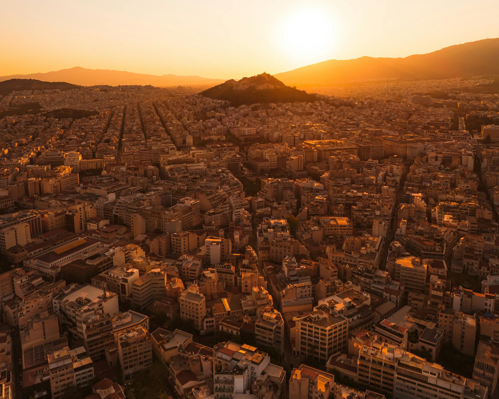 Captivating aerial view of Athens with warm sunset light over the cityscape