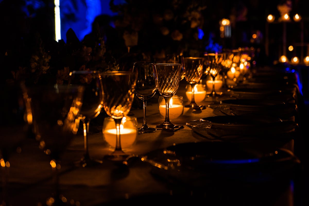 Elegant candlelit dinner table with wine glasses set for a romantic evening