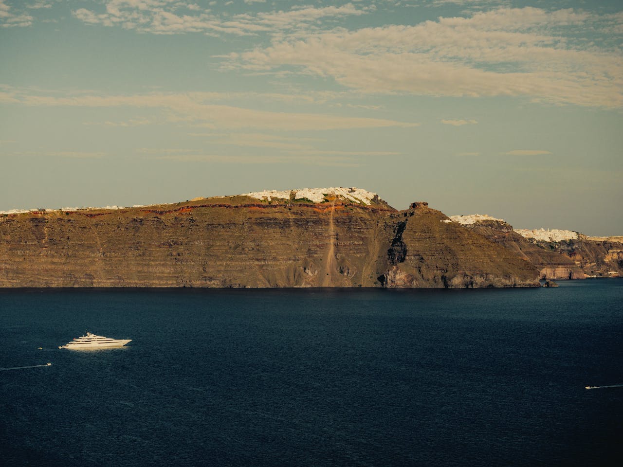 Santorini steep volcanic coastline from the water