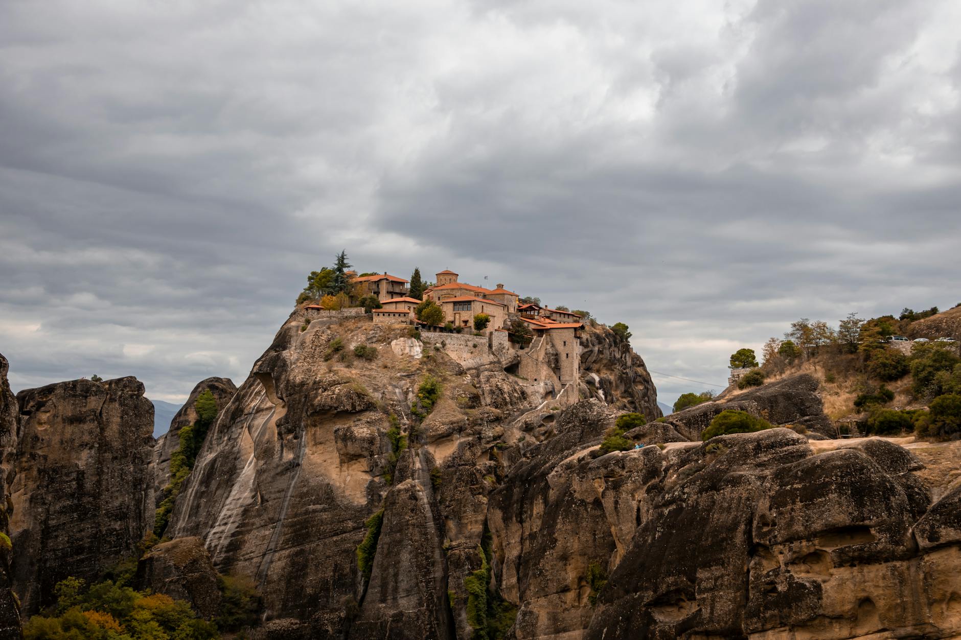 Meteora monasteries perched on towering cliffs in Greece under moody cloudy sky