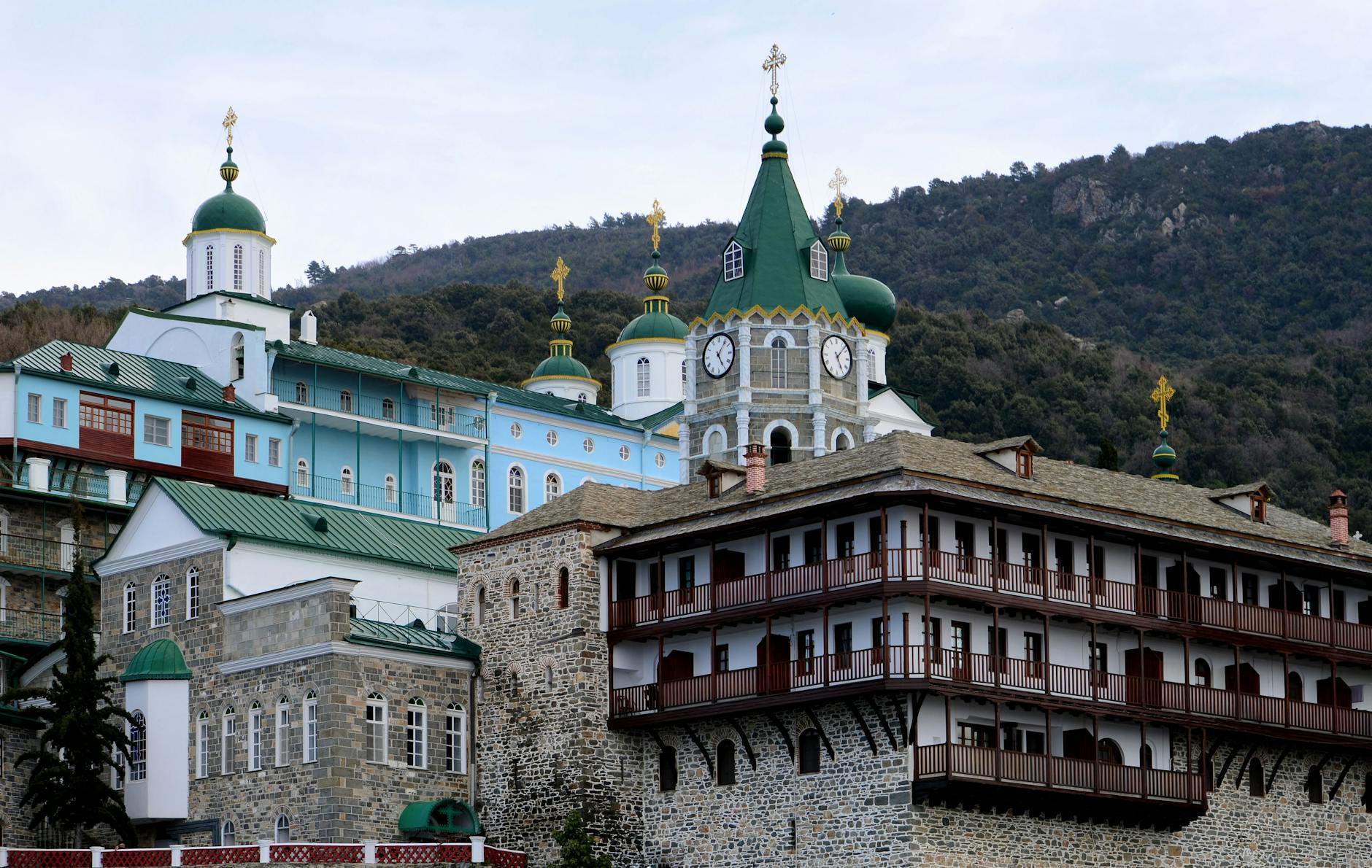 Historic Greek Orthodox monastery with intricate architecture set against mountainous landscape