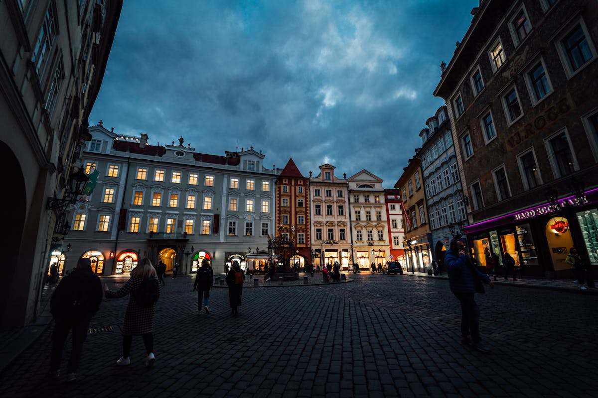 Historic Prague Old Town Square with illuminated buildings at dusk
