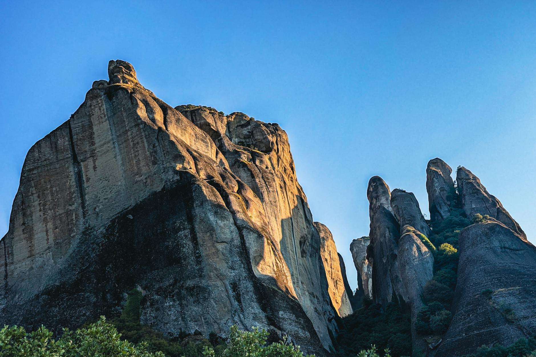 Breathtaking view of Meteora grand sandstone rock formations against clear blue sky in Greece