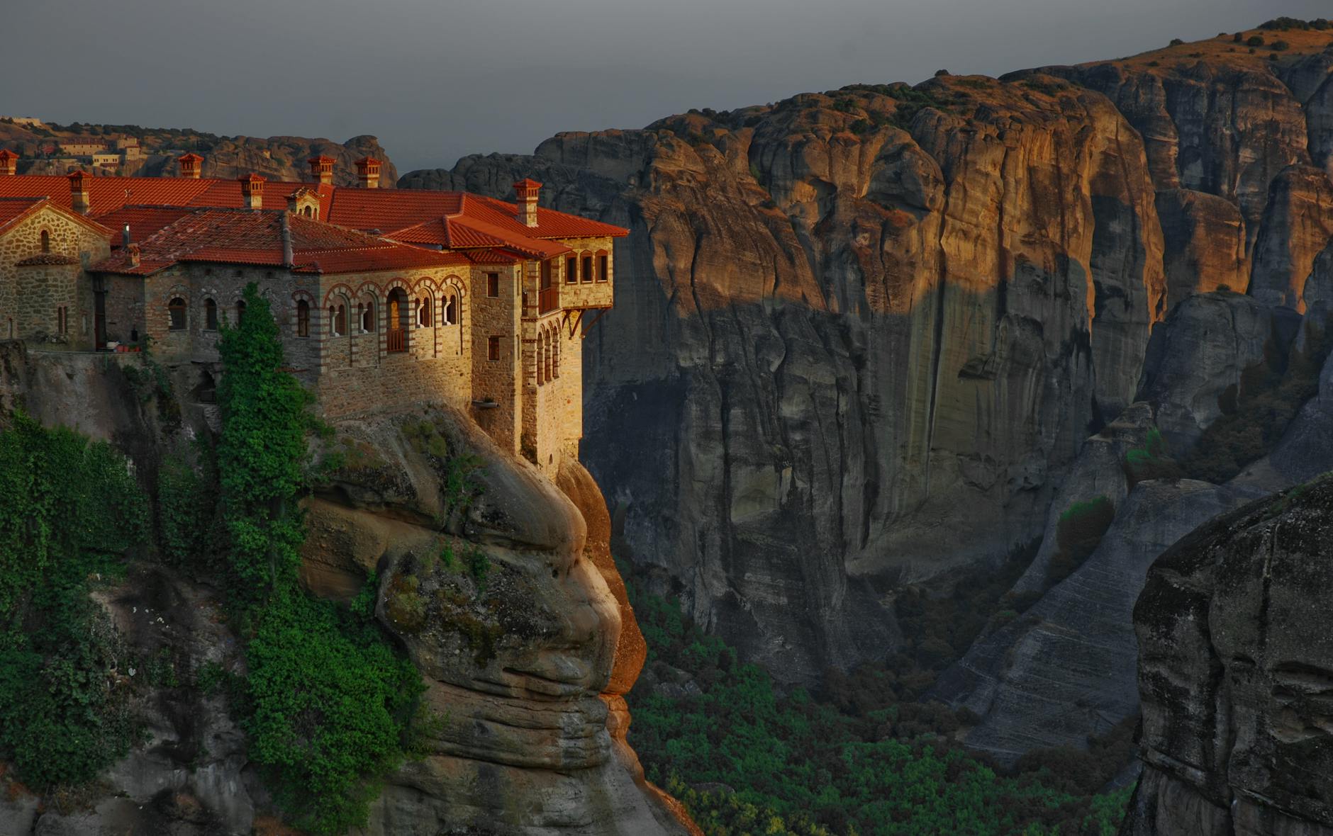 Sunset view of the Great Meteoron Monastery perched on a cliff in Meteora Greece