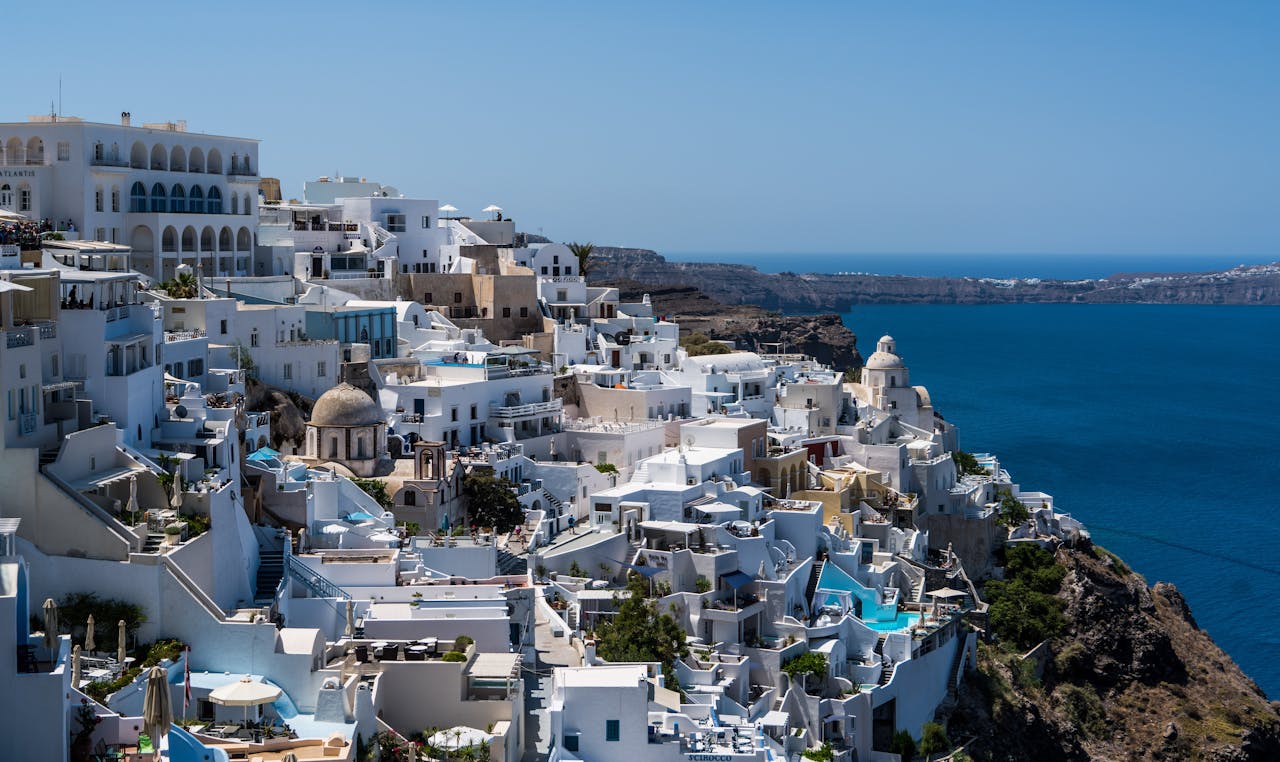 Whitewashed buildings of Santorini against blue sky
