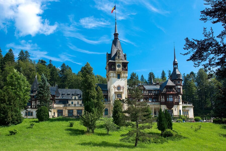 Peles Castle exterior with Carpathian mountains behind