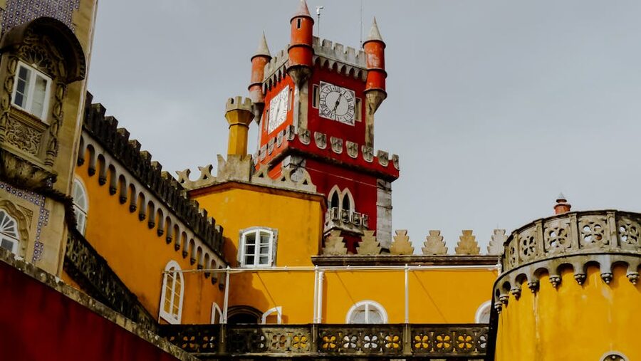 Red clock tower and ornamental dome at Pena Palace