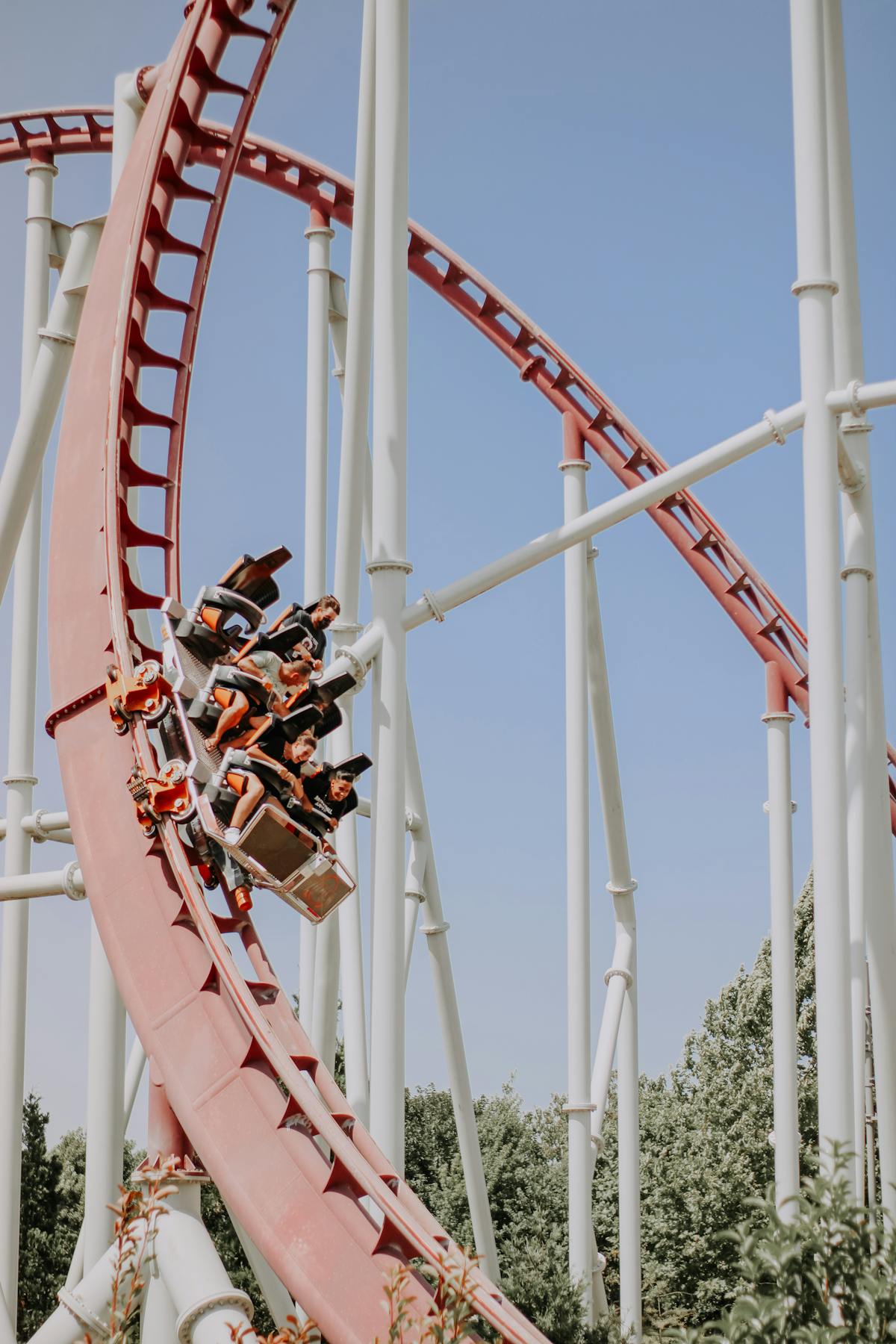People enjoying a thrilling roller coaster ride at an amusement park