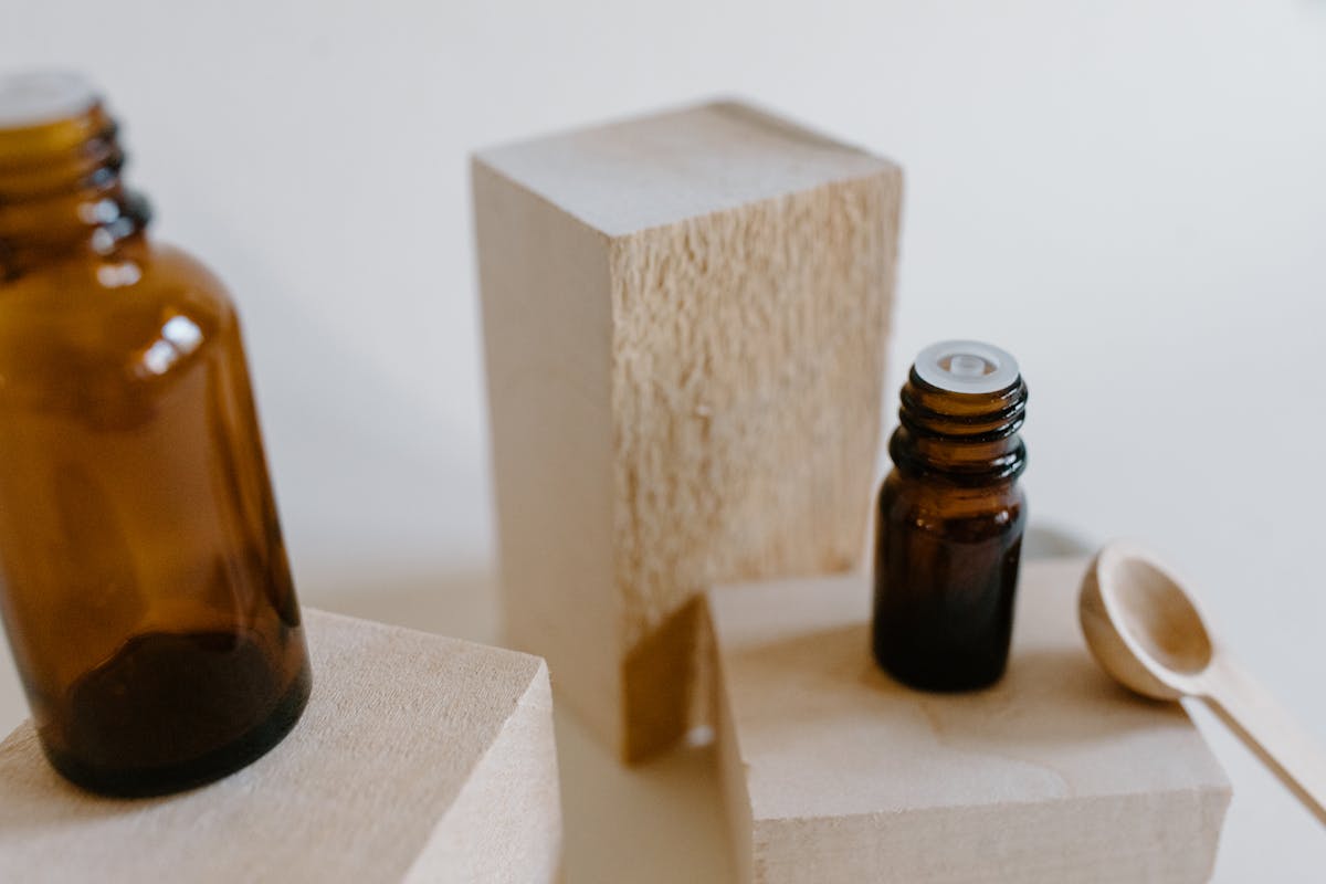 Amber essential oil bottles arranged on rustic wood