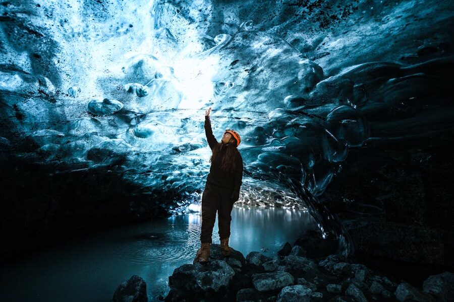 Person exploring blue ice cave Iceland