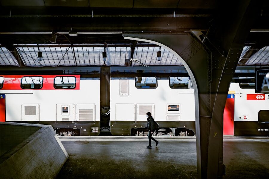 Person passing by train at Swiss station