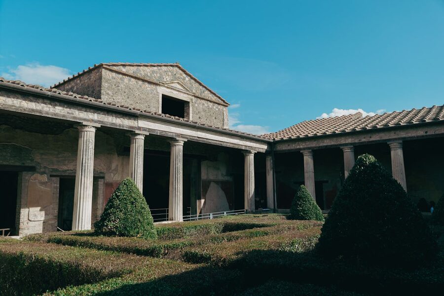 Well-preserved Roman courtyard ruins in Pompeii Italy under clear blue sky