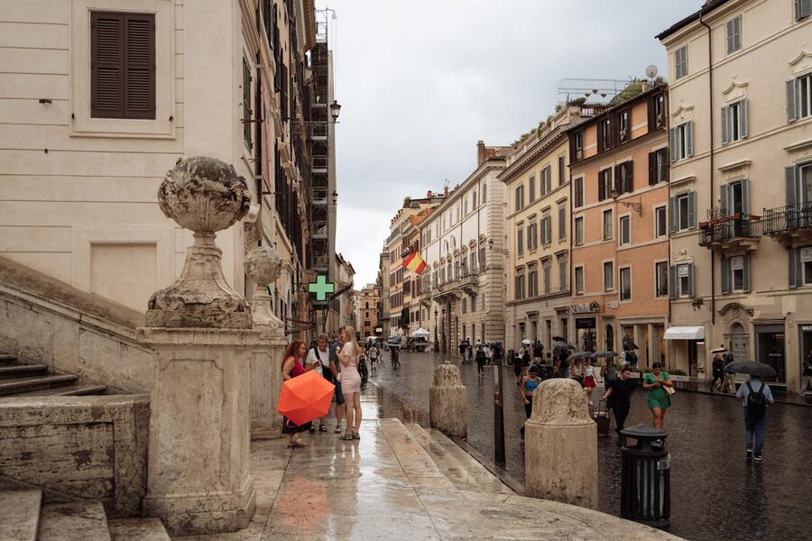 Historic Rome street with European architecture and people walking
