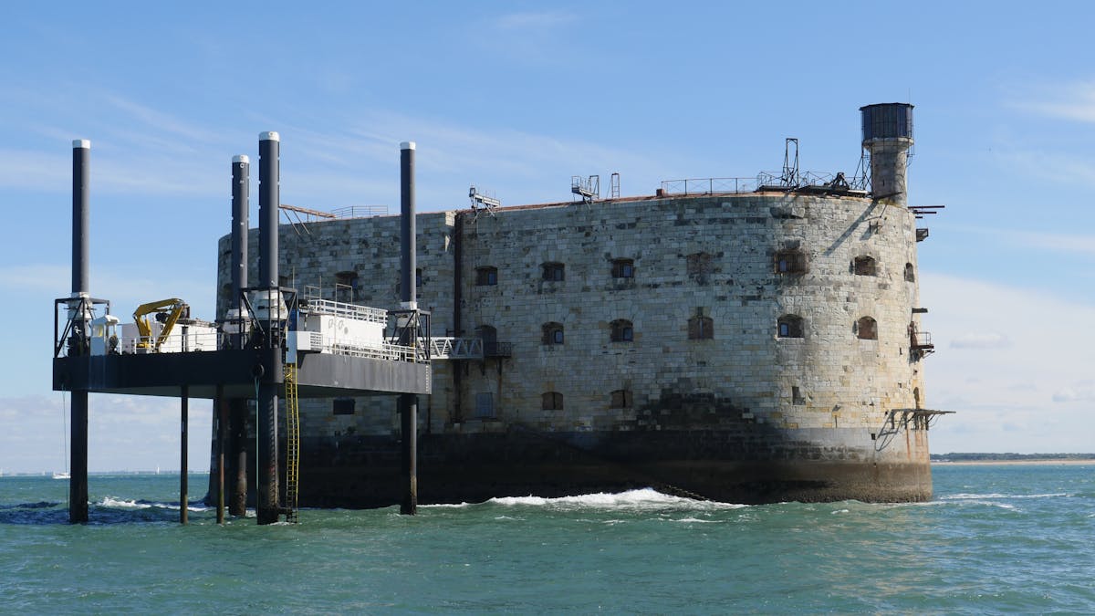 Historical Fort Boyard standing in the sea with a blue sky background