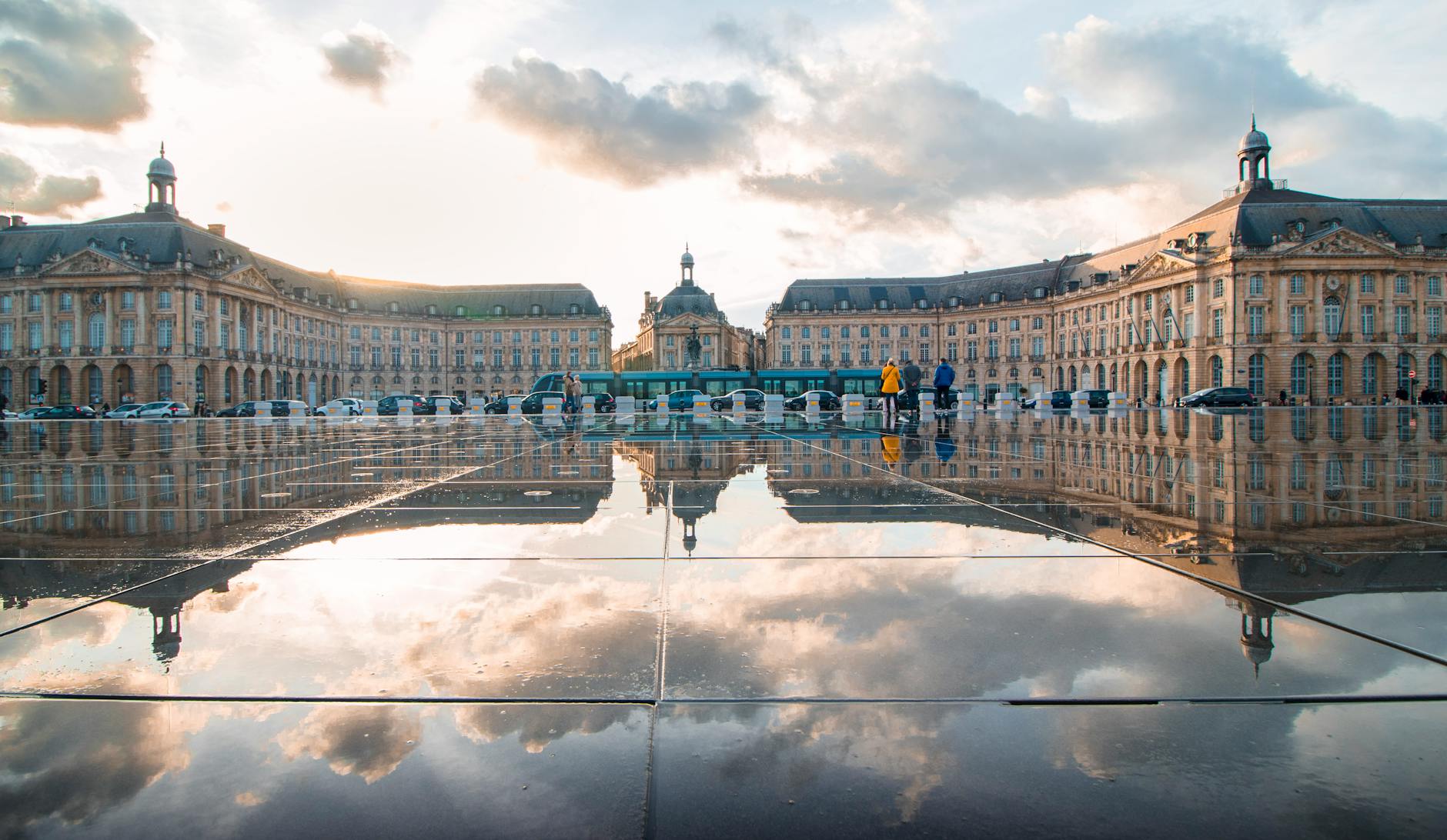 Sunset reflection at Place de la Bourse in Bordeaux France with golden light on limestone buildings