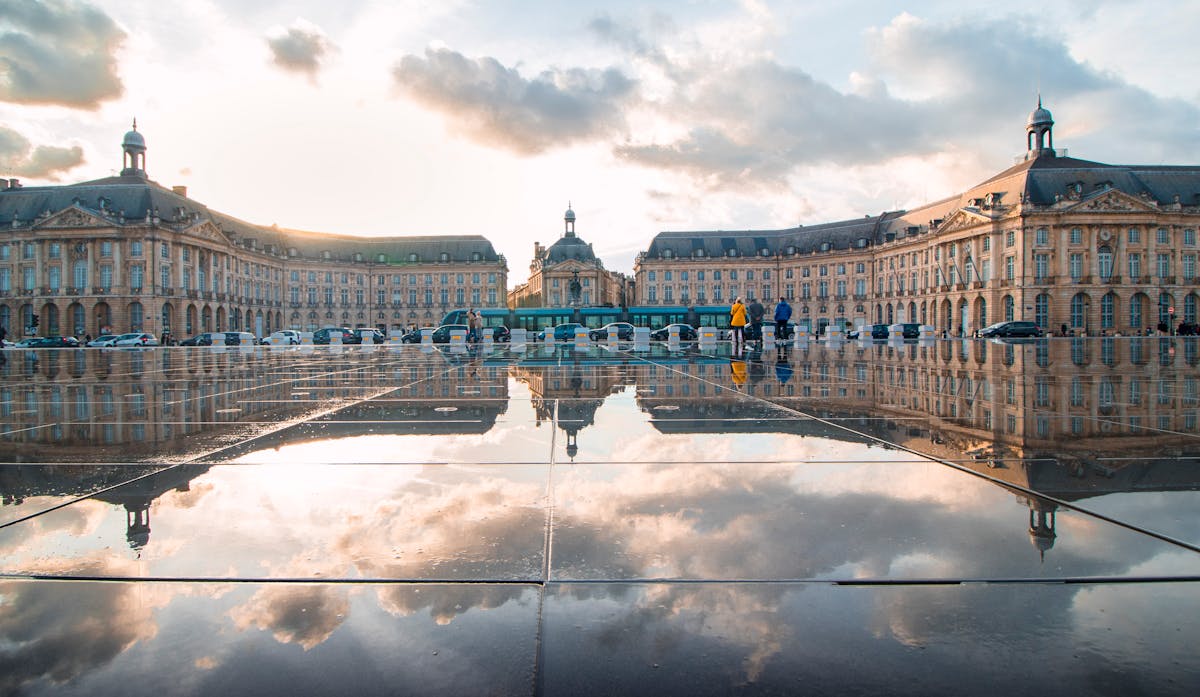 Place de la Bourse in Bordeaux reflected in the Miroir d Eau water mirror at sunset