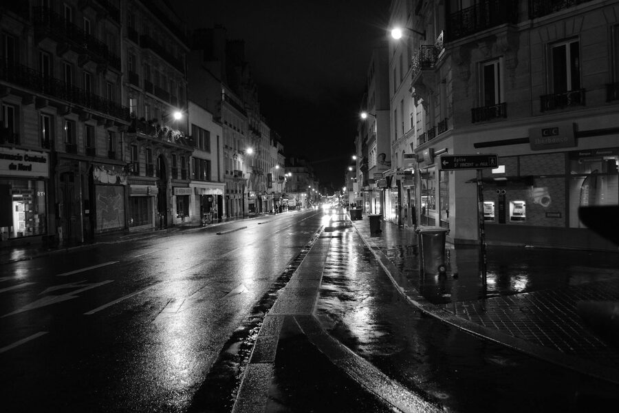 Paris street at night with neon signs and atmospheric lighting