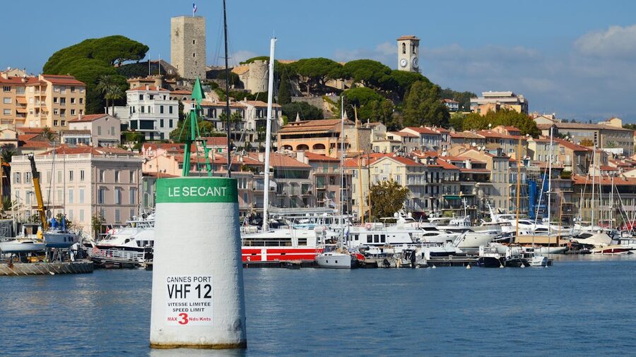 Cannes harbour with luxury yachts and historic architecture on the waterfront