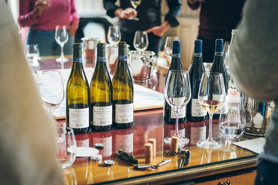 Wine bottles and glasses arranged on a table during a tasting event