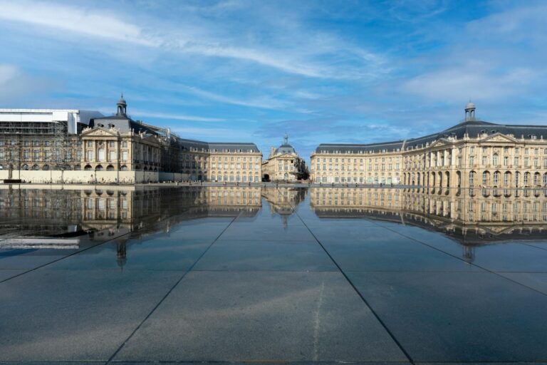 Place de la Bourse neoclassical facade reflected in the Water Mirror in Bordeaux France