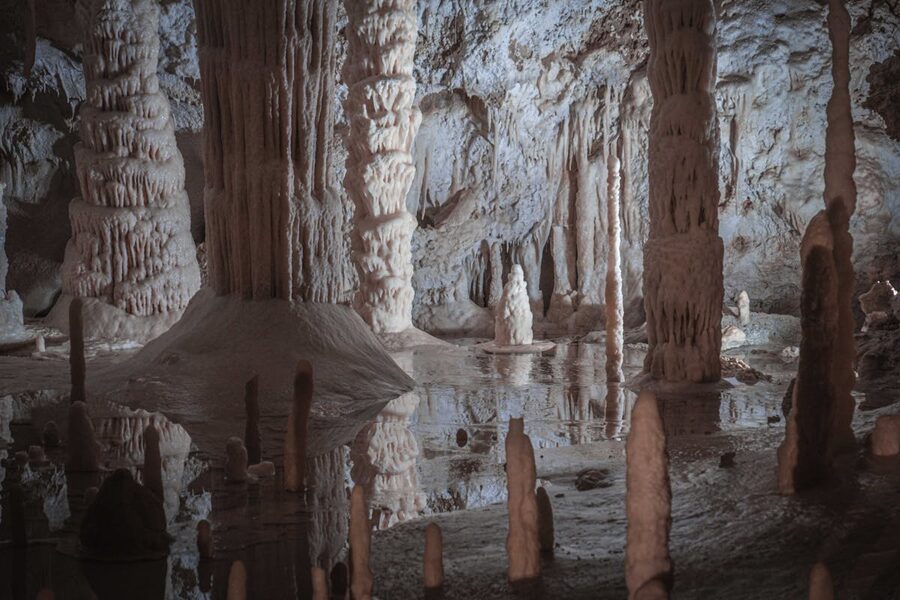 Impressive stalactites and stalagmites formations inside a large underground cave