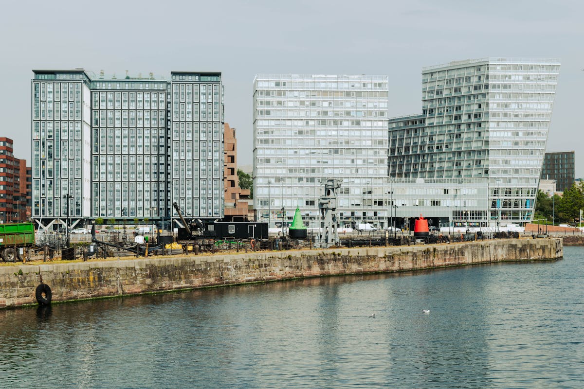 Contemporary glass buildings reflecting in the water at Canning Dock in Liverpool