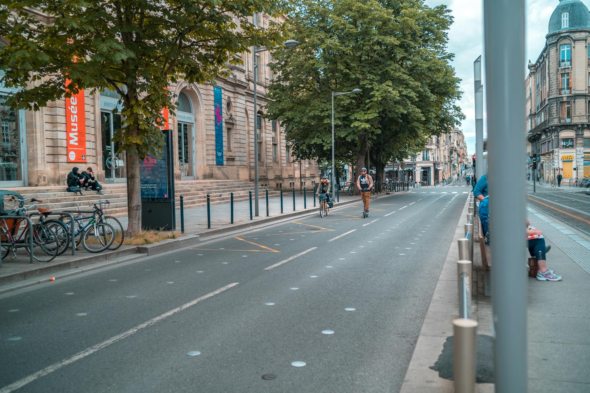 Urban street view of Bordeaux France with people biking and walking