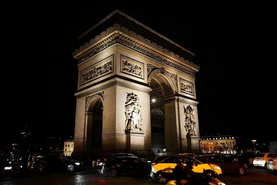 Arc de Triomphe illuminated at night in Paris