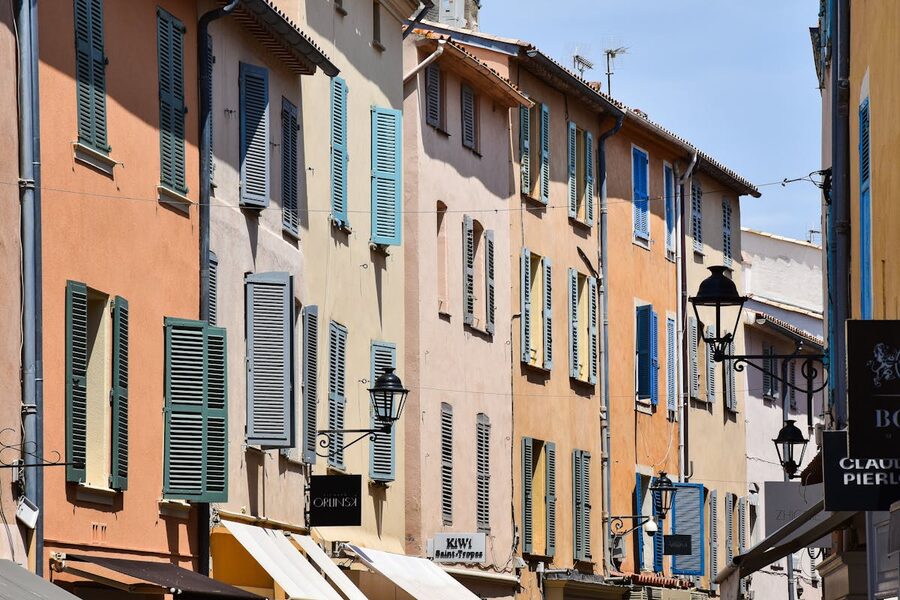 Colourful shuttered buildings lining a narrow street in Saint-Tropez old town
