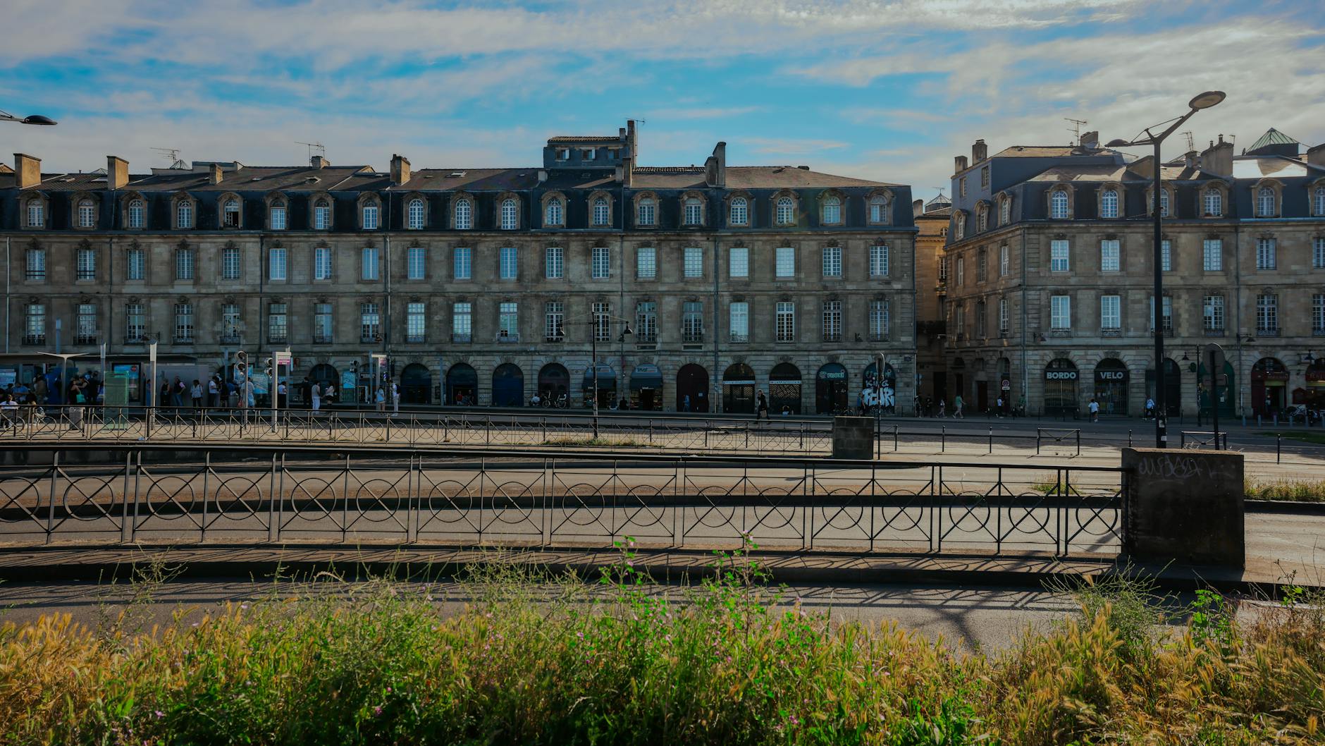 Elegant historic limestone buildings in Bordeaux France under a clear blue sky