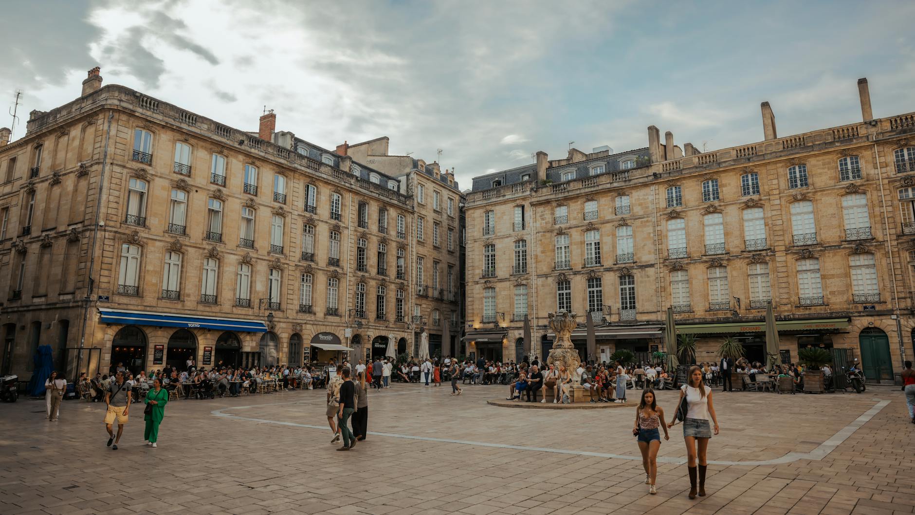 City square in Bordeaux France with people enjoying summer activities