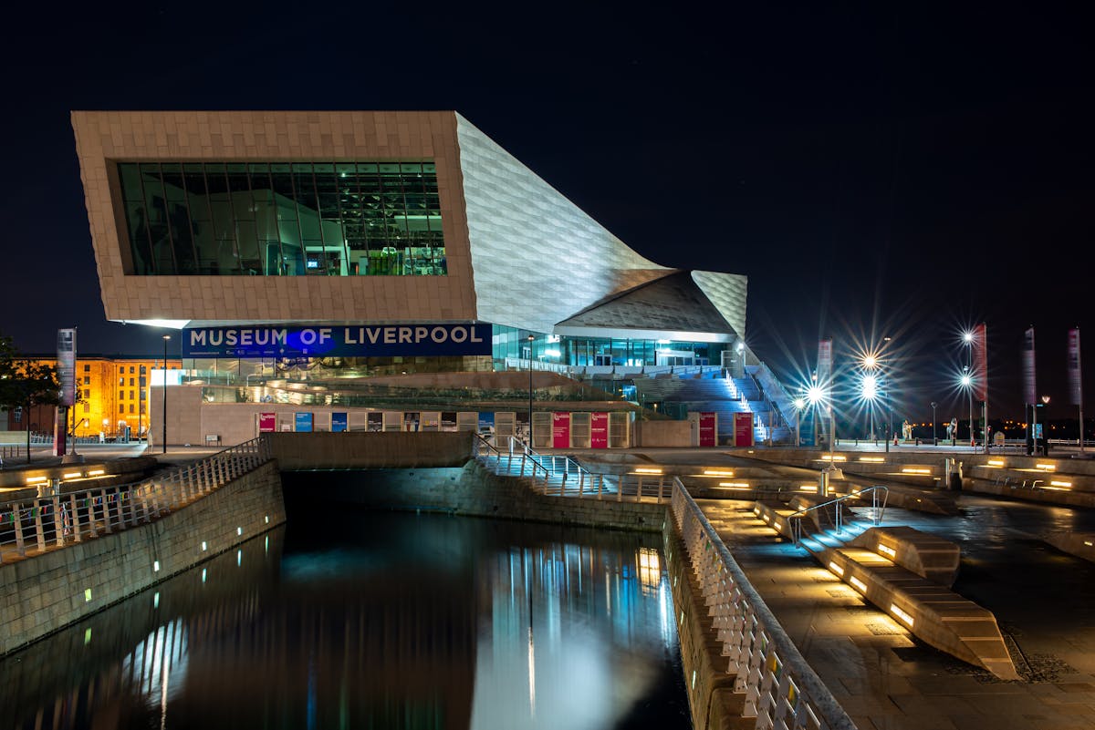 The Museum of Liverpool building illuminated at night with modern architecture