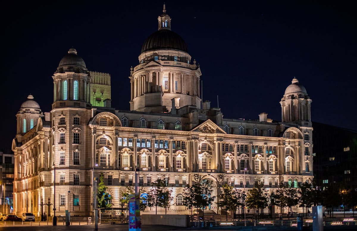 An illuminated historic building in Liverpool at night