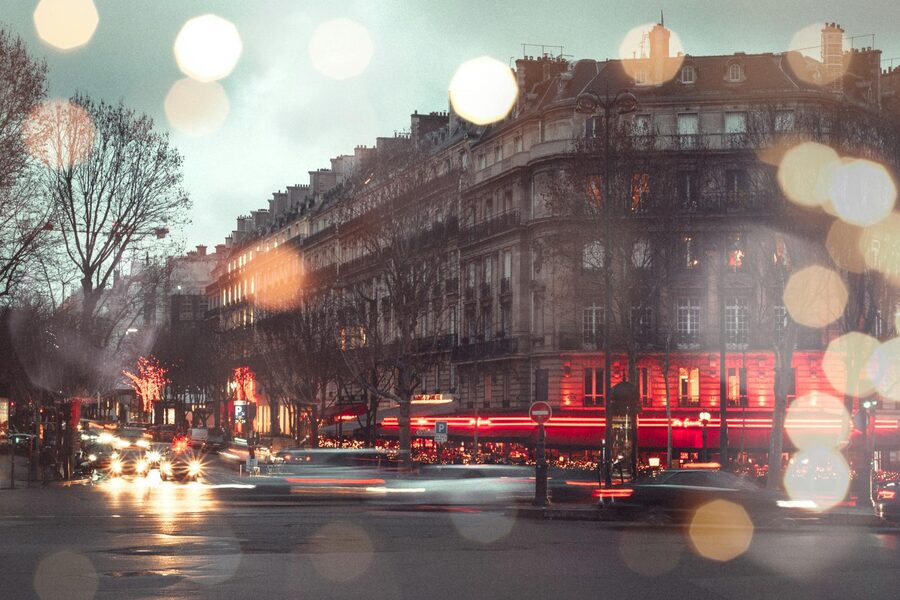 Paris boulevard at night with golden street lights and illuminated buildings