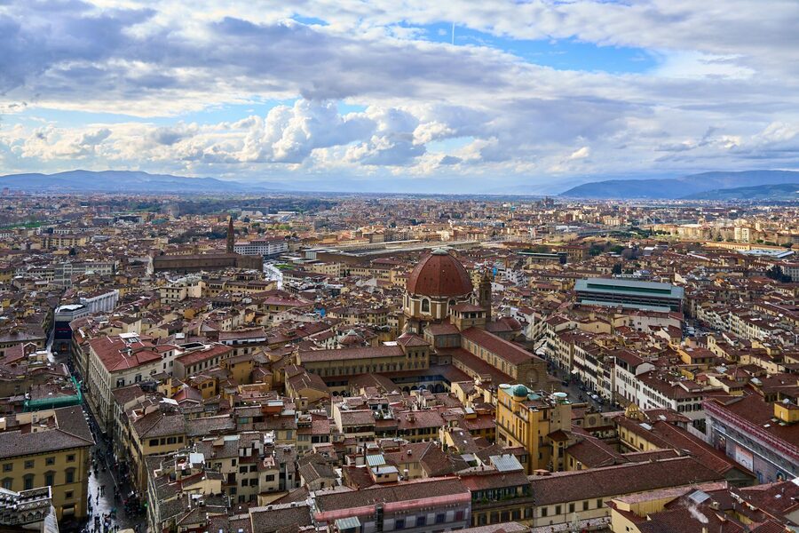 Aerial view of Florence with the Duomo cathedral dome and red terracotta rooftops stretching to the hills