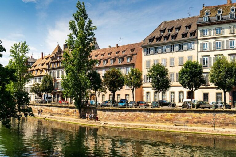 Historic half-timbered buildings reflected in the canal waters of Strasbourg