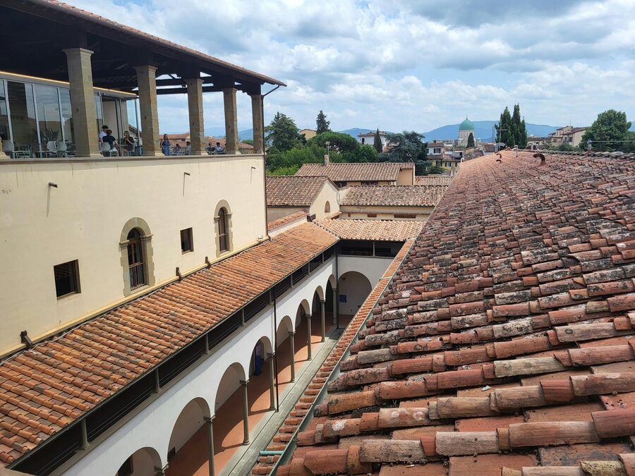 View over Florence rooftops with terracotta tiles stretching to distant Tuscan hills