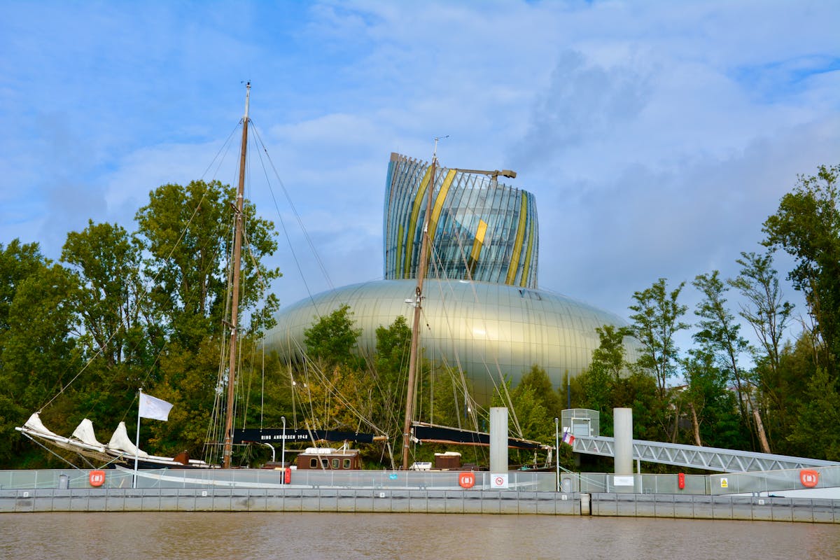 La Cite du Vin modern wine museum building with boats moored on the Garonne River in Bordeaux