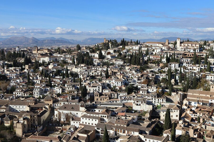 Aerial view of the historic Albaicin neighbourhood in Granada showing white-walled houses and terracotta rooftops