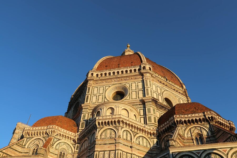 Florence Cathedral dome illuminated by morning sunlight with clear blue sky