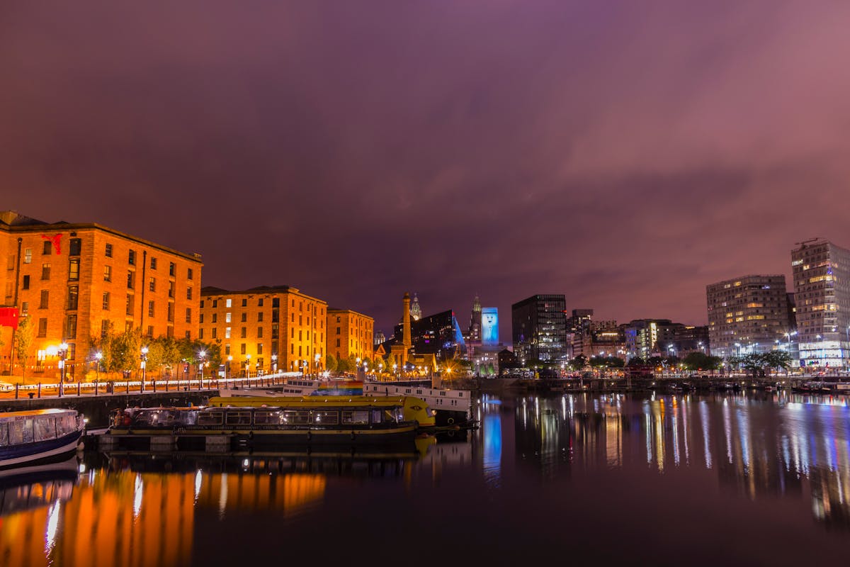 Albert Dock buildings reflected in still water at dusk in Liverpool