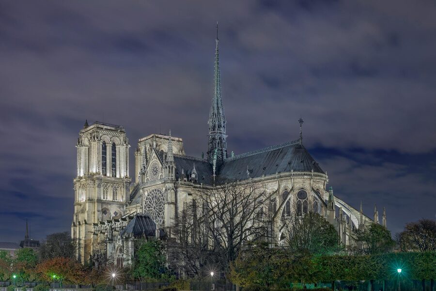 Notre Dame Cathedral at night illuminated with golden light in Paris