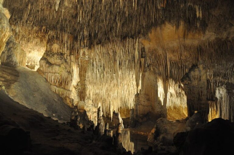 Colorful stalactite formations illuminated inside a Mallorca cave