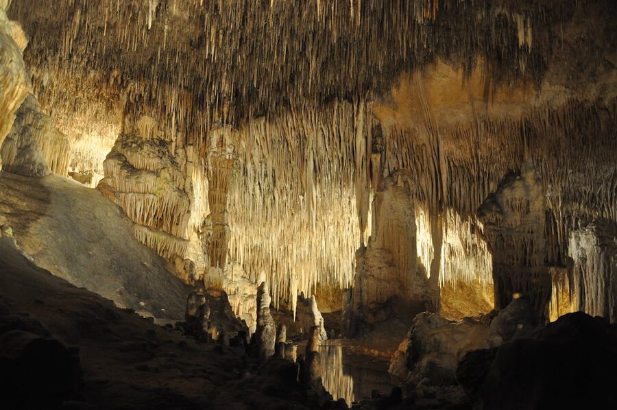 Colorful stalactite formations illuminated inside a Mallorca cave